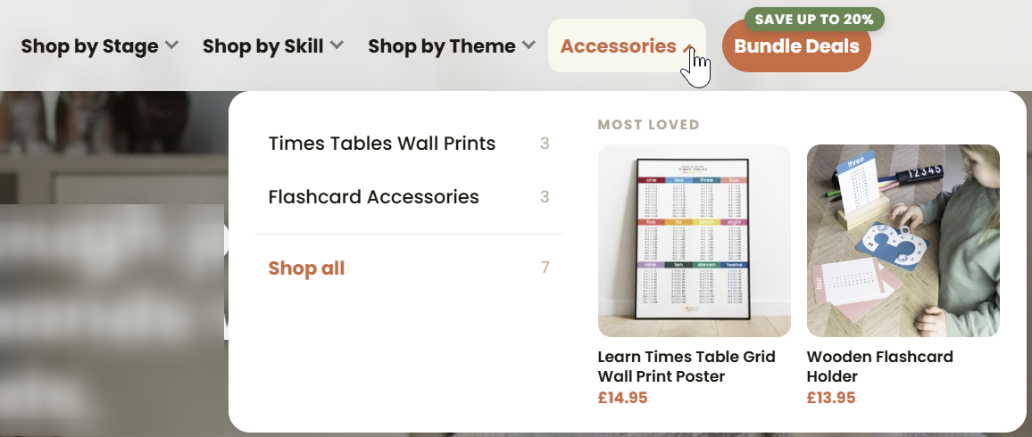 The new navigation with the Accessories dropdown open, showing Times Tables Wall Prints and Flashcard Accessories, beside a Bundle Deals button